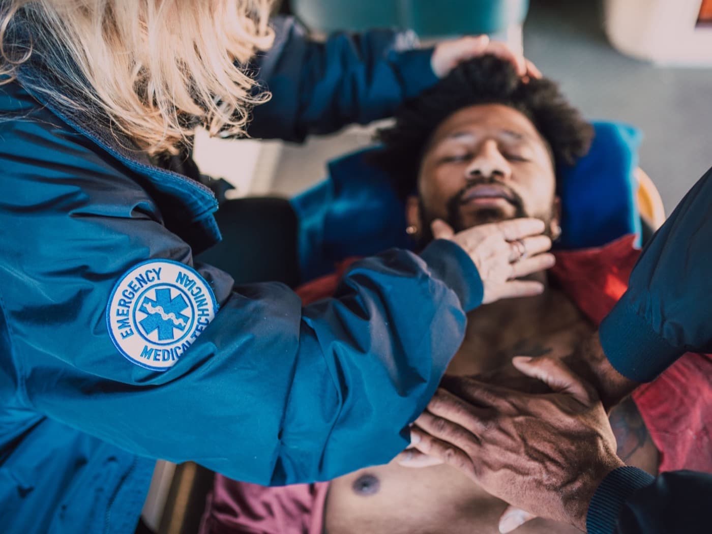 Emergency medical technicians assessing and stabilizing an injured patient